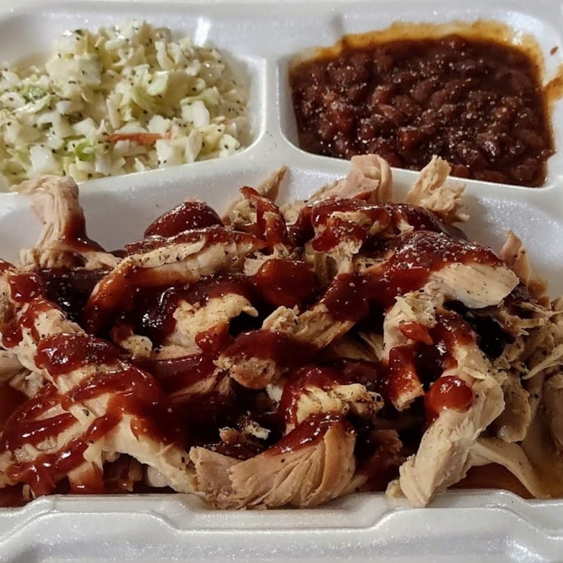 Pappies Smokehouse & Lunch Box BBQ chicken with coleslaw and baked beans in a styrofoam container.